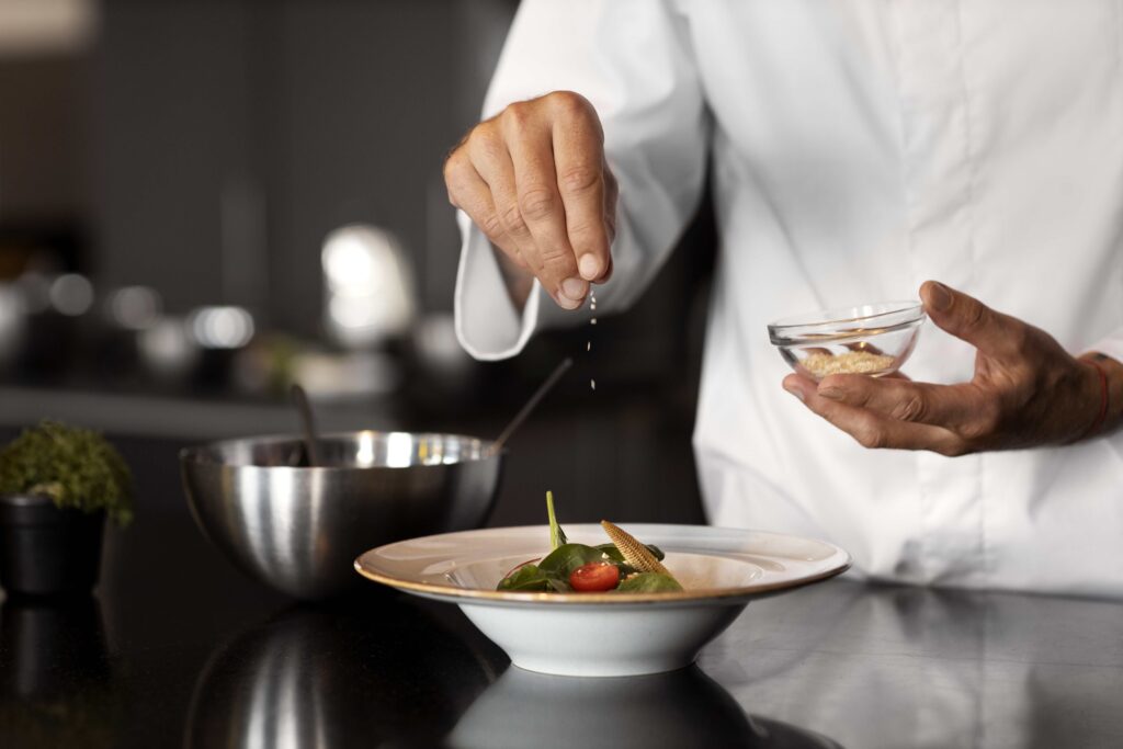 Professional chef preparing a gourmet dish in a culinary arts kitchen